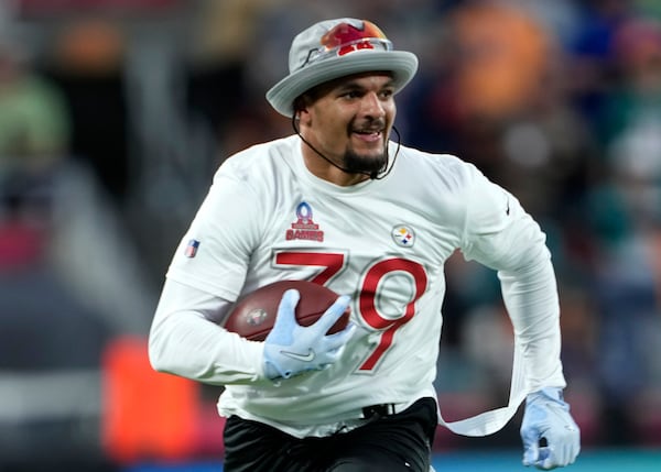 FILE - AFC free safety Minkah Fitzpatrick (39), of the Pittsburgh Steelers, runs back an interception for a touchdown during the flag football event at the NFL Pro Bowl Games on Sunday, Feb. 2, 2025, in Orlando, Fla. (Doug Benc/AP Images for NFL, file)