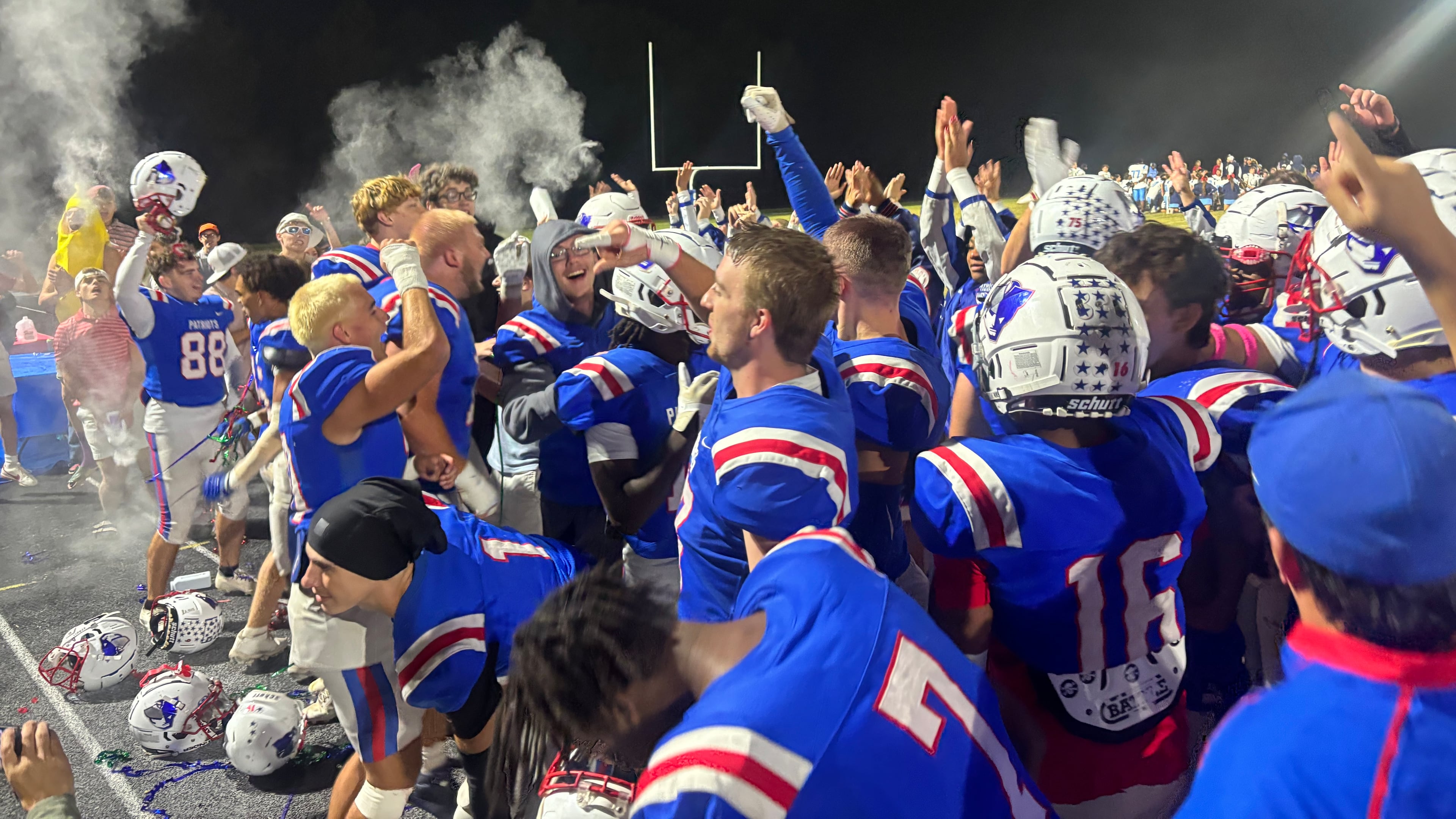 Oglethorpe County football players celebrate with the student section after clinching a state playoff spot with a 34-7 win over Providence Christian on Friday, Oct. 24, 2025. (Jack Leo/AJC)