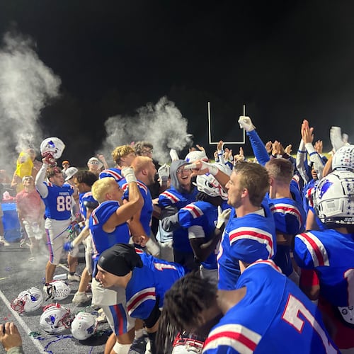 Oglethorpe County football players celebrate with the student section after clinching a state playoff spot with a 34-7 win over Providence Christian on Friday, Oct. 24, 2025. (Jack Leo/AJC)