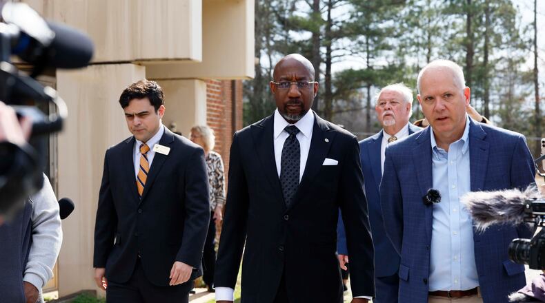 Social Circle City Manager Eric Taylor (right) walks with U.S. Sen. Raphael Warnock (center), D-Ga., as they tour a city water treatment facility on Monday, March 2, 2026. Social Circle officials say the administration's plan to use a warehouse as an immigration detention facility would put too much pressure on the city's water and sewer resources and remove more than $1 million from its tax rolls. (Miguel Martinez/AJC)