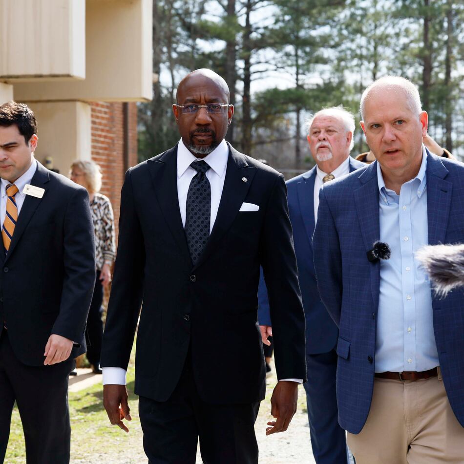 Social Circle City Manager Eric Taylor (right) walks with U.S. Sen. Raphael Warnock (center), D-Ga., as they tour a city water treatment facility on Monday, March 2, 2026. Social Circle officials say the administration's plan to use a warehouse as an immigration detention facility would put too much pressure on the city's water and sewer resources and remove more than $1 million from its tax rolls. (Miguel Martinez/AJC)