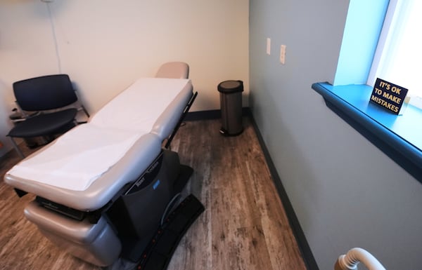 An "It's OK to Make Mistakes" sign rests on a window sill next to an examination table at the Maine Family Planning healthcare facility, July 15, 2025, in Thomaston, Maine. (AP Photo/Charles Krupa)