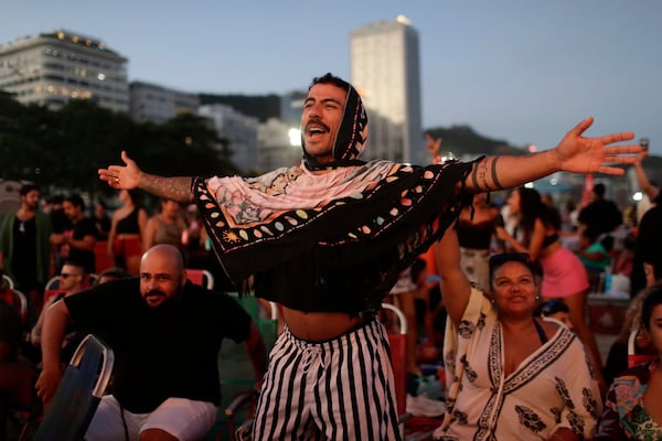 A fan cheers while waiting for the start of Lady Gaga's free concert on Copacabana beach in Rio de Janeiro, Saturday, May 3, 2025. (AP Photo/Bruna Prado)