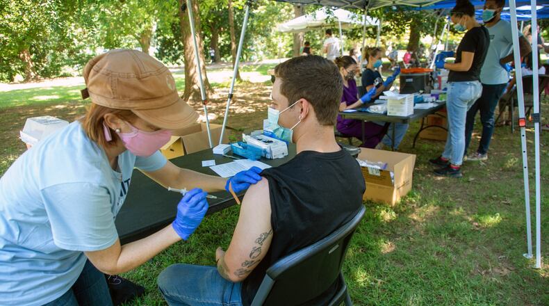 Emory University Physician Assistant student Nicole Groff gives Gage Kirby his vaccination shot during the Atlanta Jazz Festival in Piedmont Park on Sunday, September 5, 2021. The vaccinations were coordinated by Emory’s outbreak response team. STEVE SCHAEFER FOR THE ATLANTA JOURNAL-CONSTITUTION
