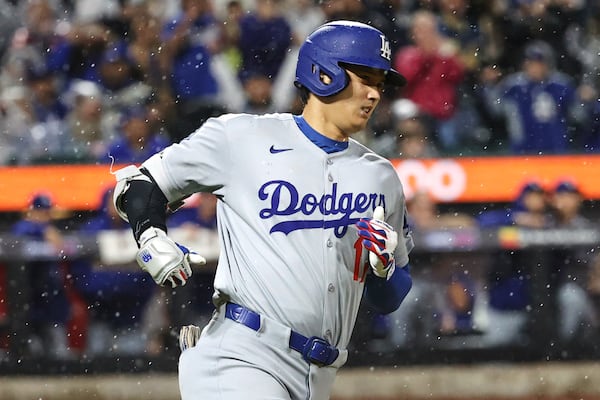 Los Angeles Dodgers' Shohei Ohtani runs to first base after hitting a single during the ninth inning of a baseball game against the New York Mets, Friday, May 23, 2025, in New York. (AP Photo/Pamela Smith)