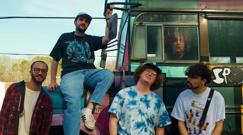 Atlanta band Dinner Time will perform in the Battery following the Braves game on Aug. 7 at part of the Spencer Strider Vinyl Record Giveaway. Members are (from left) London Cameron, Andrew Joyce, Ian Buford and Alejandro Uribe -- with touring drummer Gideon Johnston peering out the bus window.
(Courtesy of Dinner Time / Gianna Zaffino)
