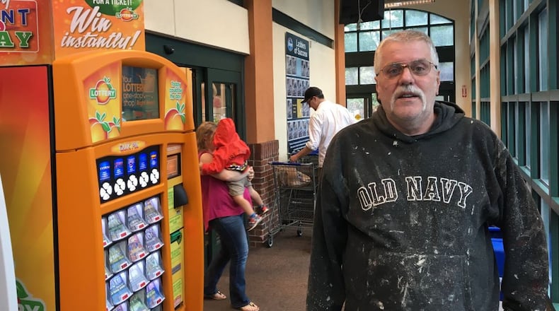 Herb Lugsdin loaded up on the necessities beer and a lotto ticket. Mark Niesse Photo/MNIESSE@AJC.COM