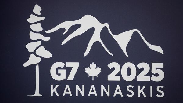 A logo for the G7 2025 Kananaskis meeting is pictured at a news conference in Banff, Alberta, Canada, Thursday, May 22, 2025. (Jeff McIntosh/The Canadian Press via AP)