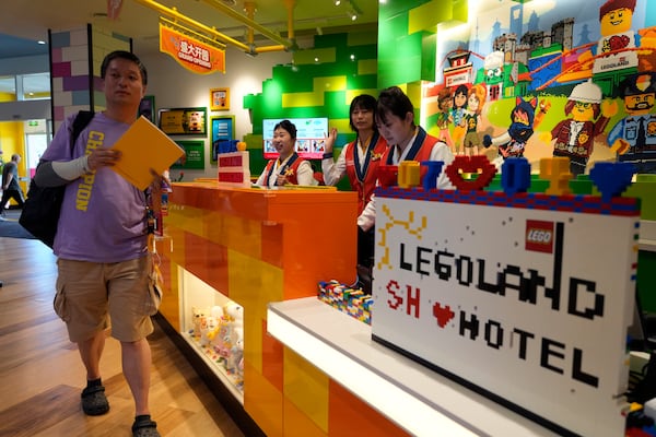 Workers attend to visitors at the hotel in Legoland Shanghai a day before it opens to the public in Shanghai, China, Friday, July 4, 2025. (AP Photo/Ng Han Guan)