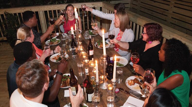 Civic Dinners are being staged in Atlanta and elsewhere around the country to bring people from different backgrounds together in an effort to restart our public discourse. The concept was created by Atlanta entrepreneur Jenn Graham, seen at the center (in red) of this gathering. CONTRIBUTED BY JENN GRAHAM