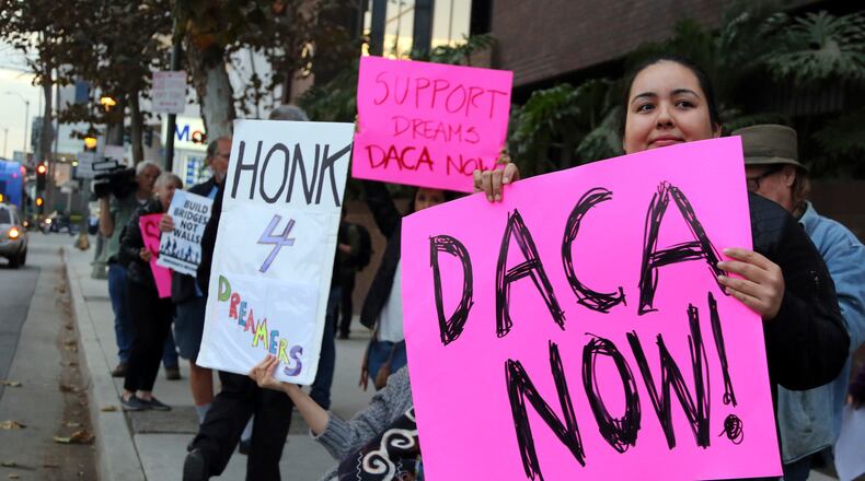 Demonstrators urging the Democratic Party to protect the Deferred Action for Childhood Arrivals Act (DACA) rally outside the office of California Democratic Sen. Dianne Feinstein in Los Angeles Wednesday, Jan. 3, 2018. California has the largest number of people who are affected by the law, also known as the Dream Act.(AP Photo/Reed Saxon)