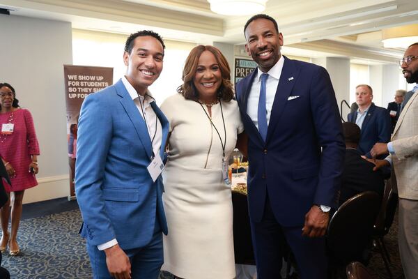 Karyn Greer (center) poses with her son, T.J. Anthony (left), and Atlanta Mayor Andre Dickens after Dickens spoke in April at the Commerce Club in downtown Atlanta. (Courtesy of Atlanta Press Club)