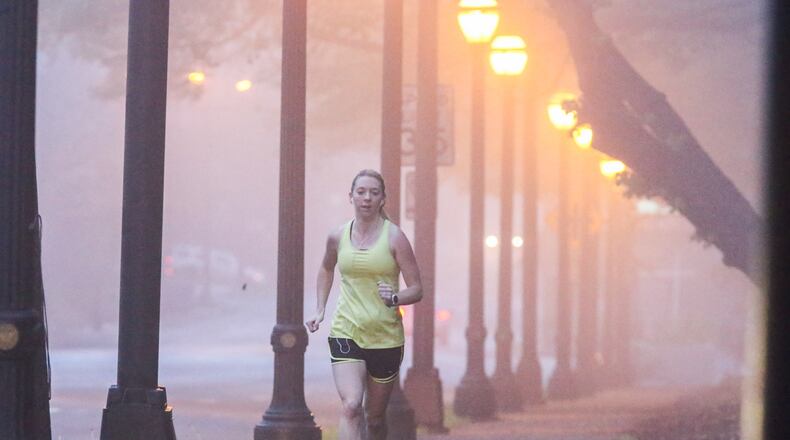 Patchy fog in Atlanta early Tuesday did not stop Molly Slesnick from completing her 8-mile run, which took her through Piedmont Avenue. JOHN SPINK / JSPINK@AJC.COM
