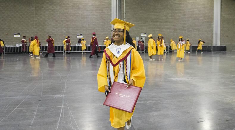 Marisela Lozada smiles as she walks to meet her family after graduating from Maynard Jackson High School at the Georgia World Congress Center on May 22, 2018. The center is not available for 2019 high school graduation ceremonies, causing school districts to have to search for other big venues. ALYSSA POINTER/ATLANTA JOURNAL-CONSTITUTION