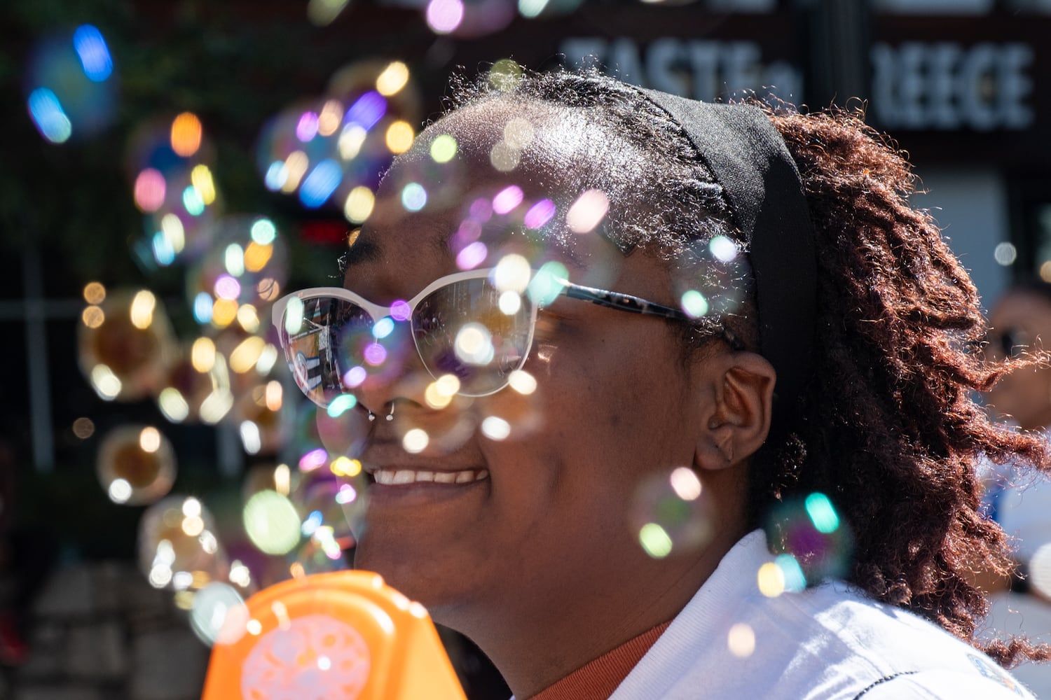 Simora Gaines shoots bubbles as she participates in the Atlanta Pride Parade on Sunday, Oct. 12, 2025. (Ben Gray for the AJC)