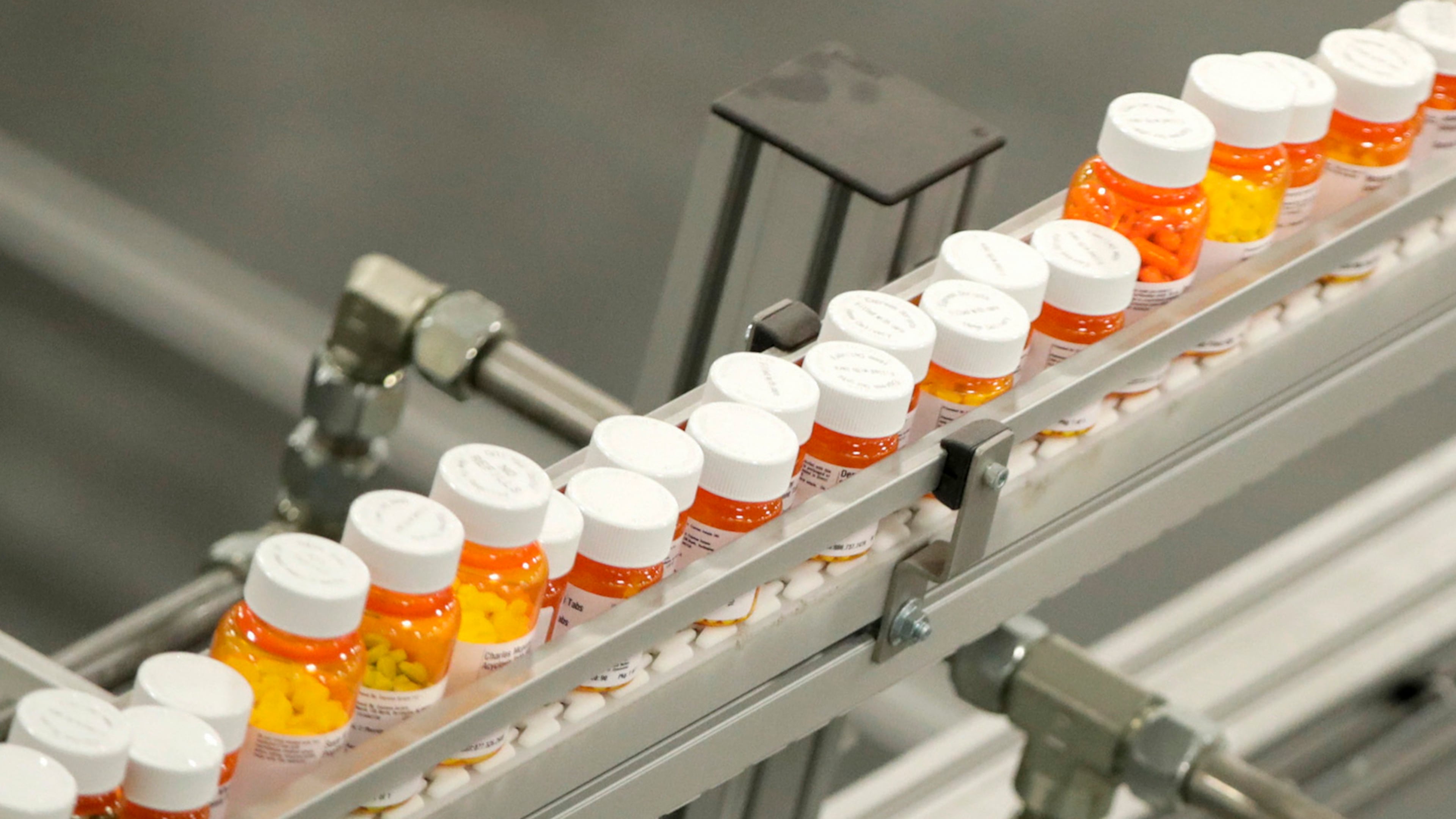 Bottles of medicine ride on a belt at a mail-in pharmacy warehouse in Florence, N.J., July 10, 2018. . (Julio Cortez/AP)