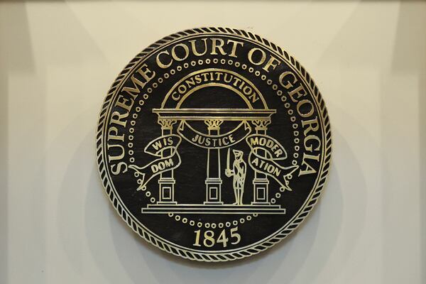 The seal for the Georgia Supreme Court hangs inside the Nathan Deal Judicial Center in Atlanta. (Jason Getz/AJC)