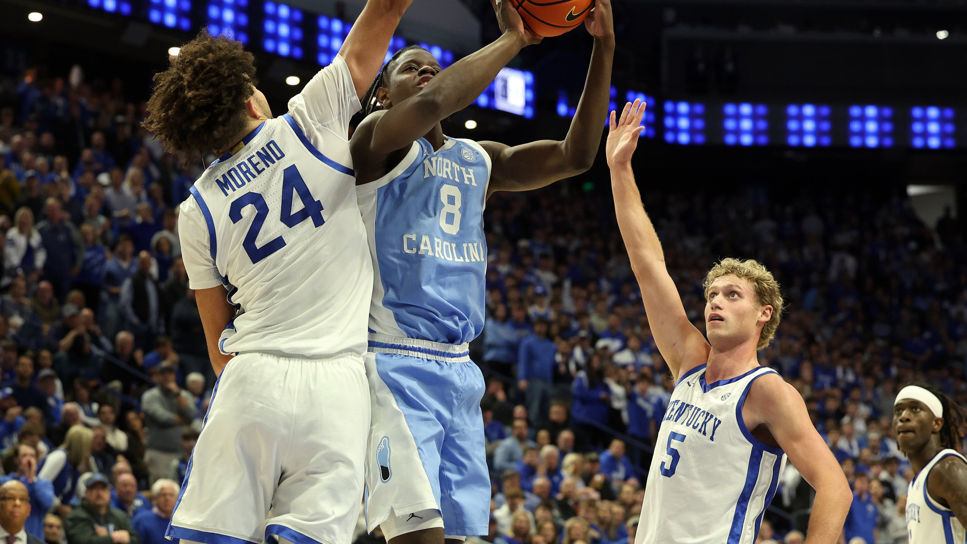 North Carolina's Caleb Wilson (8) shoots between Kentucky's Malachi Moreno (24) and Collin Chandler (5) during the second half of an NCAA college basketball game in Lexington, Ky., Tuesday, Dec. 2, 2025. (AP Photo/James Crisp)
