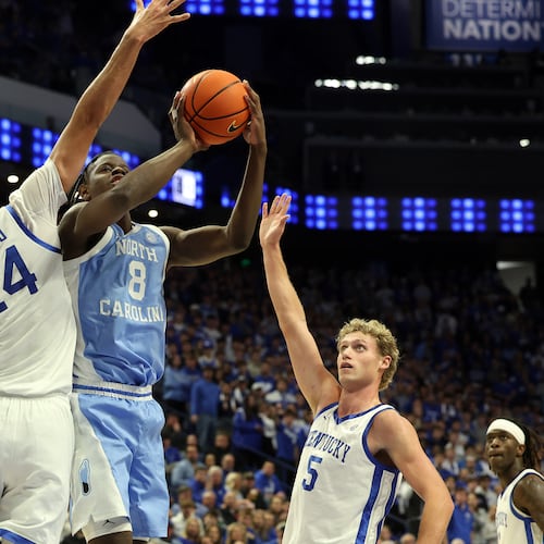 North Carolina's Caleb Wilson (8) shoots between Kentucky's Malachi Moreno (24) and Collin Chandler (5) during the second half of an NCAA college basketball game in Lexington, Ky., Tuesday, Dec. 2, 2025. (AP Photo/James Crisp)