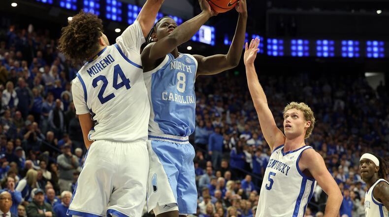 North Carolina's Caleb Wilson (8) shoots between Kentucky's Malachi Moreno (24) and Collin Chandler (5) during the second half of an NCAA college basketball game in Lexington, Ky., Tuesday, Dec. 2, 2025. (AP Photo/James Crisp)