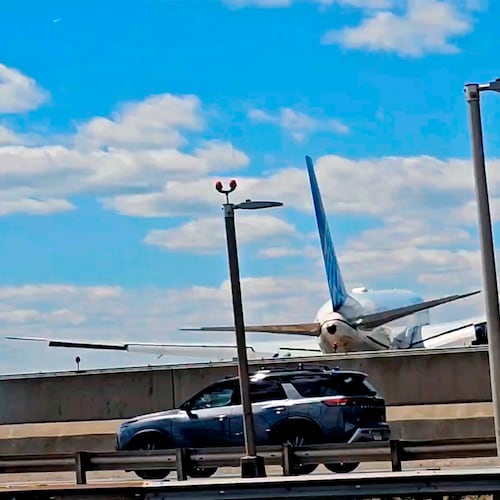 A United Airlines plane is seen in a still image taken from video after hitting a semitrailer truck and a light pole on the New Jersey Turnpike as it lands at Newark Liberty International Airport, Sunday, May 3, 2026. (Patrick Oyulu, via AP)