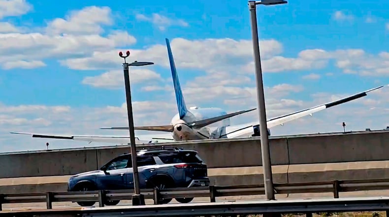 A United Airlines plane is seen in a still image taken from video after hitting a semitrailer truck and a light pole on the New Jersey Turnpike as it lands at Newark Liberty International Airport, Sunday, May 3, 2026. (Patrick Oyulu, via AP)