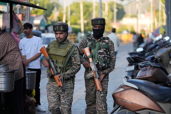 Indian paramilitary soldiers patrol as they guard at a busy market in Srinagar, Indian controlled Kashmir, Tuesday, April 29, 2025. (AP Photo/Mukhtar Khan)