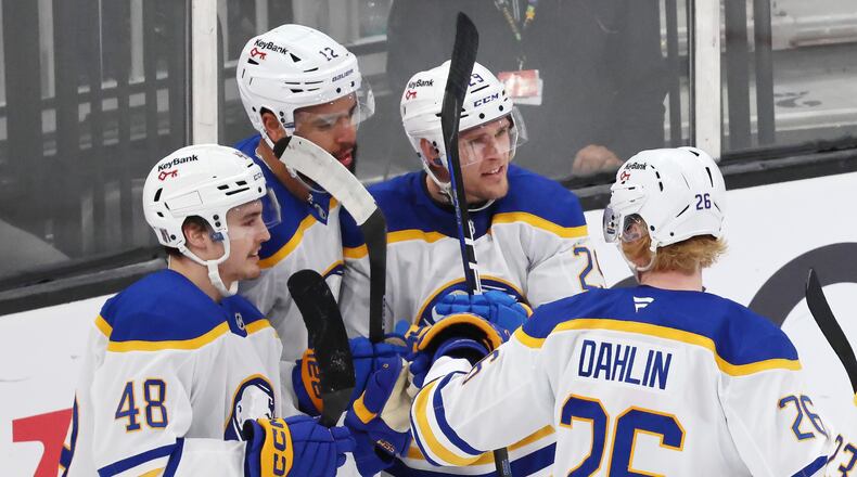 Buffalo Sabres' Beck Malenstyn (29) celebrates after his goal with teammates Tyson Kozak (48), Jordan Greenway (12) and Rasmus Dahlin (26) during the third period in Game 4 of a first-round NHL hockey Stanley Cup playoff series against the Boston Bruins, Sunday, April 26, 2026 against the Boston Bruins, in Boston. (AP Photo/Michael Dwyer)