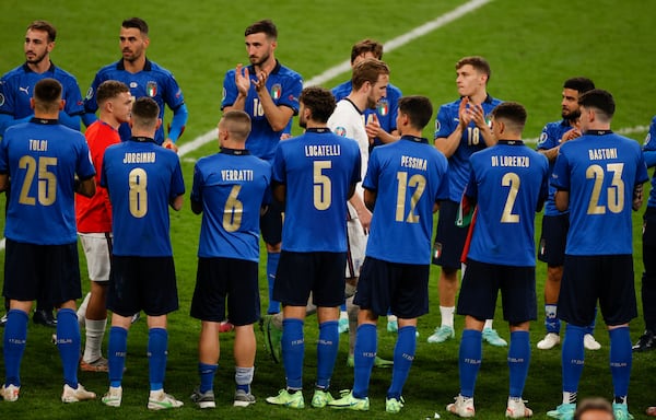 FILE - England's Harry Kane walks through the Italian players to receive his runner-up medal following their loss to Italy in the Euro 2020 soccer championship final at Wembley stadium in London, Sunday, July 11, 2021. (John Sibley/Pool Photo via AP, file)