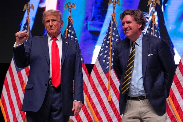 FILE - Republican presidential nominee former President Donald Trump speaks with Tucker Carlson during a Tucker Carlson Live Tour show at Desert Diamond Arena, Oct. 31, 2024, in Glendale, Ariz. (AP Photo/Julia Demaree Nikhinson, File)