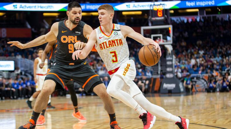 Hawks guard Kevin Huerter drives against Nikola Vucevic of the Magic during the first half of Monday's game in Orlando. (AP Photo/Willie J. Allen Jr.)