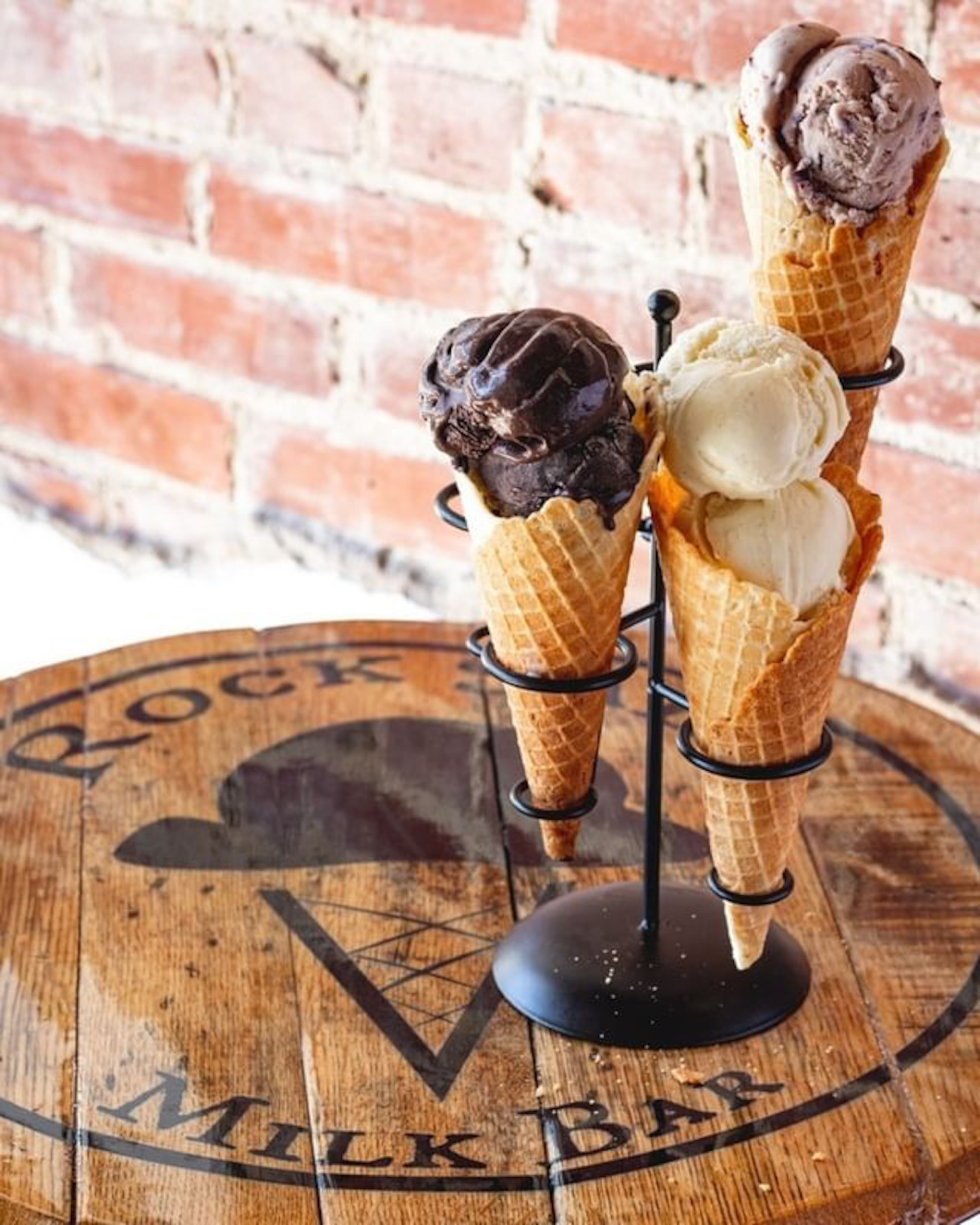 From left, scoops of dark chocolate, blackberry Earl Grey, and honey lavender ice creams fill from-scratch cones at Rock Salt Milk Bar. (Shaleen Munsell)