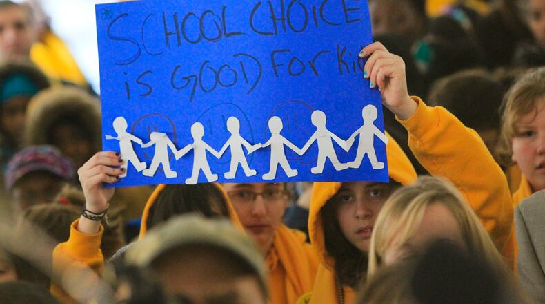110125 Atlanta: Signs were everywhere Tuesday during the rally. Hundreds of parents and students attended the School Choice Celebration and Rally at the Georgia State Capitol Tuesday, Jan. 25, 2011. The gathering rallied to push state lawmakers to expand educational options for Georgia families. The event joined together unlikely allies, public and private school leaders in a display of unity where they urged lawmakers to expand scholarship opportunities so parents can better afford to pick their children's schools. Private schools want the state to raise the $50 million cap on the tax-credit scholarship that has helped hundreds of public school students transfer to private schools. Charter school officials want the state to support the continued funding of their campuses, which faces a state Supreme Court challenge from a handful of Georgia public school systems. The rally comes as the country celebrates National School Choice Week. David Pusey, director of a Center for an Educated Georgia, said more metro Atlanta parents appear to be concerned about choice than ever before, especially with accreditation problems at Atlanta Public Schools. John Spink jspink@ajc.com A state Supreme Court ruling today means the program that provides tax exemptions to those who contribute to scholarships for students to use at private schools, including religious schools, will remain in place.