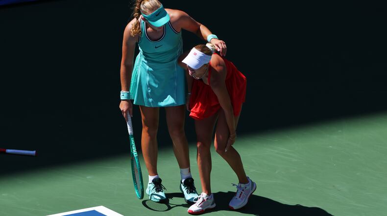 Mirra Andreeva, of Russia, left, helps Anastasia Potapova, of Austria, after Potapova fell during the fourth round of the U.S. Open tennis championships, Monday, Sept. 7, 2026, in New York. (AP Photo/Andres Kudacki)