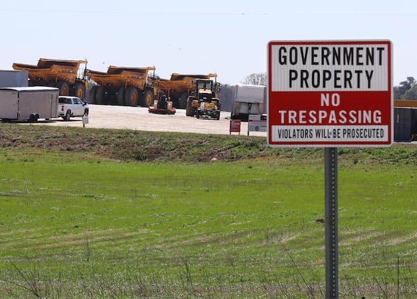 Heavy-duty grading equipment is parked at a construction entrance beside Davis Academy Road on the site of Rivian’s planned Georgia plant in Rutledge. (Curtis Compton for the AJC 2024)