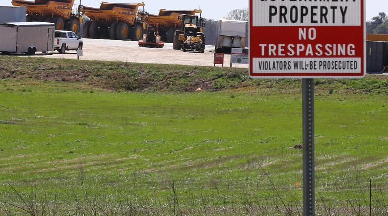 Heavy-duty grading equipment is parked at a construction entrance beside Davis Academy Road on the site of Rivian’s Georgia plant on Sunday, March 10, 2024, in Rutledge. The money-losing electric vehicle company, which makes vans, trucks and SUVs, is trying to preserve cash and will delay construction of a $5 billion factory. The company had nearly completed preparing the roughly 1,800-acre site about 50 miles east of Atlanta. Curtis Compton for the Atlanta Journal Constitution