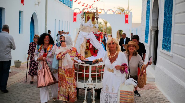 Jewish pilgrims take part in a procession as they attend an annual pilgrimage at the Ghriba synagogue in the resort of Djerba, Tunisia, on Monday, May 4, 2026. (AP Photo/Bassem Aouini)