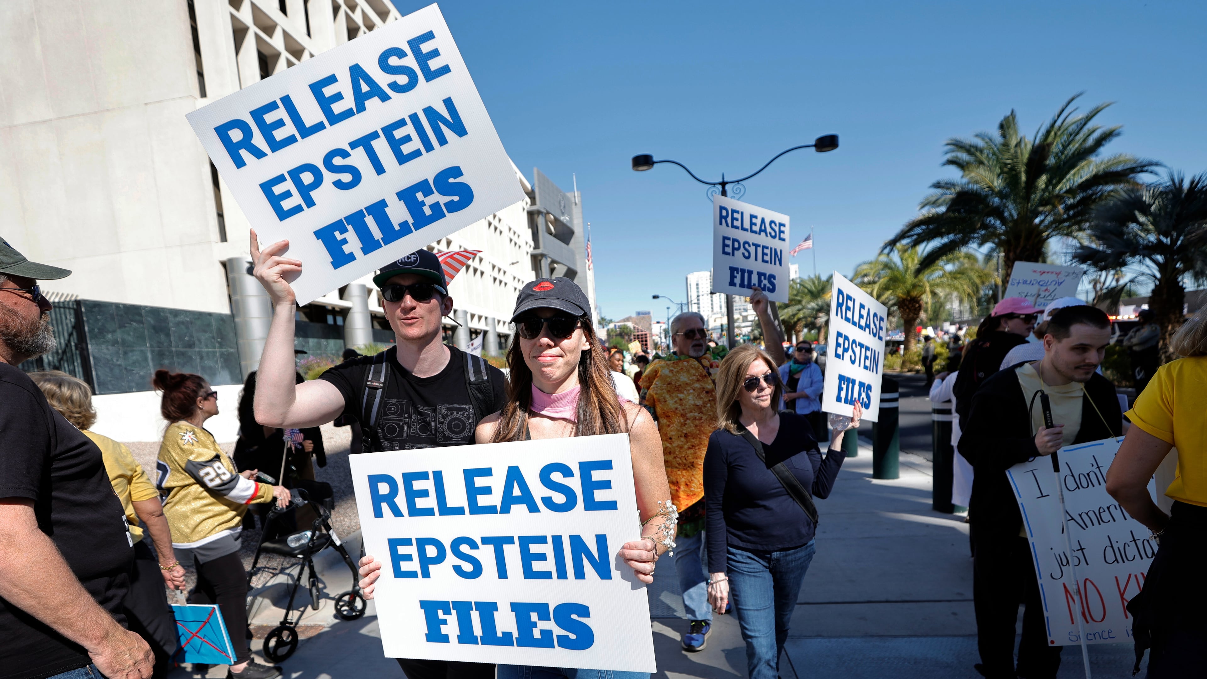 Demonstrators hold signs asking for the release of the Epstein files during a "No Kings" protest in downtown Las Vegas Saturday, Oct. 18, 2025. (Steve Marcus /Las Vegas Sun via AP)