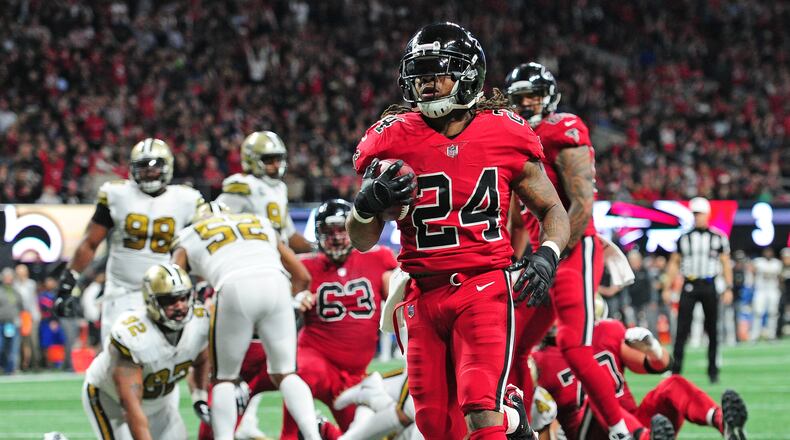 ATLANTA, GA - DECEMBER 7: Devonta Freeman #24 of the Atlanta Falcons carries the ball for a touchdown against the New Orleans Saints at Mercedes-Benz Stadium on December 7, 2017 in Atlanta, Georgia. (Photo by Scott Cunningham/Getty Images)