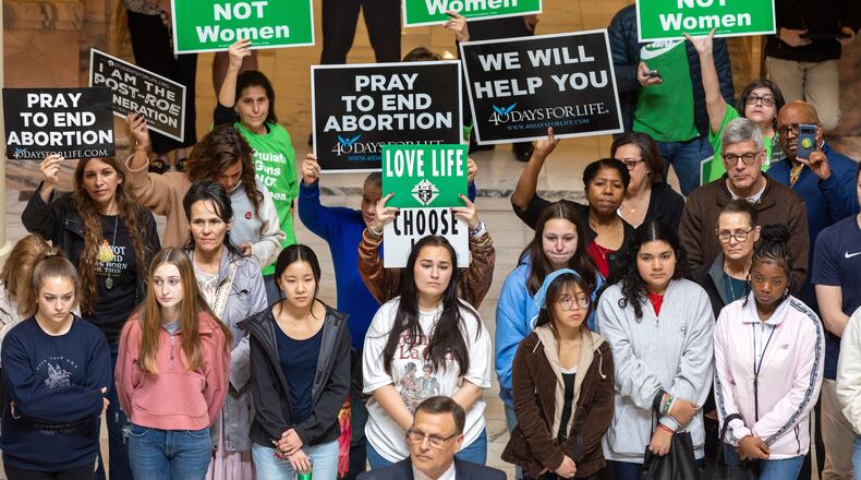 Activists who support abortion rights and abortion opponents hold signs expressing their views at an anti-abortion rally at the Georgia Capitol in February 2023. (Arvin Temkar/AJC)