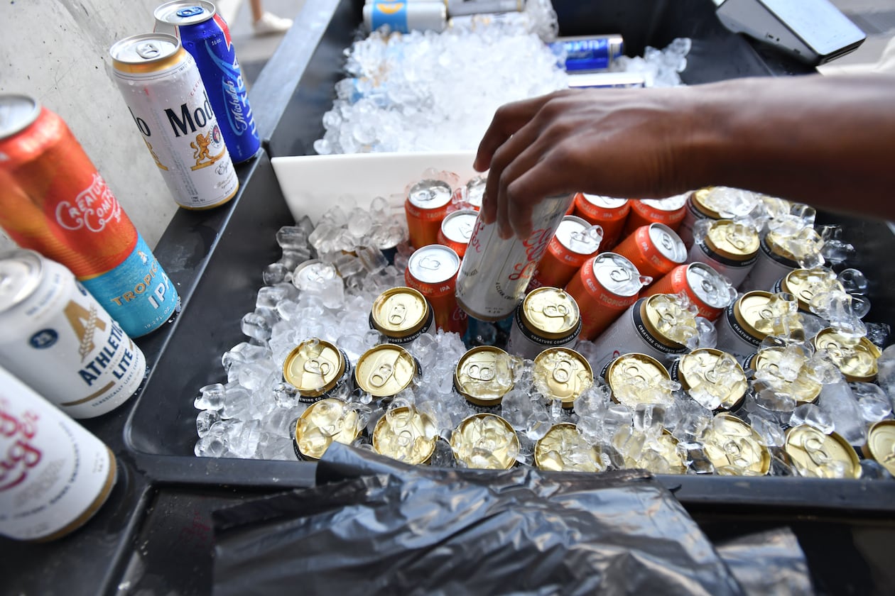 Georgia football fans buy beers before the Bulldogs' home opener against Tennessee Tech at Sanford Stadium in September 2024. (Hyosub Shin/AJC)