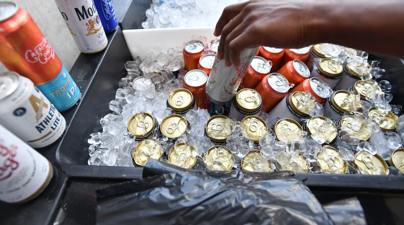 Georgia football fans buy beers before the Bulldogs' home opener against Tennessee Tech at Sanford Stadium in September 2024. (Hyosub Shin/AJC)