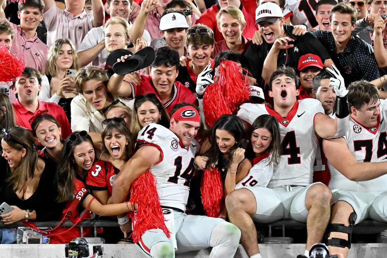 Georgia quarterback Gunner Stockton (14) and other players celebrate with fans after Georgia beat Florida during an NCAA football game, Saturday, November 1, 2025, Jacksonville, Fla. Georgia won 24-20 over Florida. (Hyosub Shin / AJC)