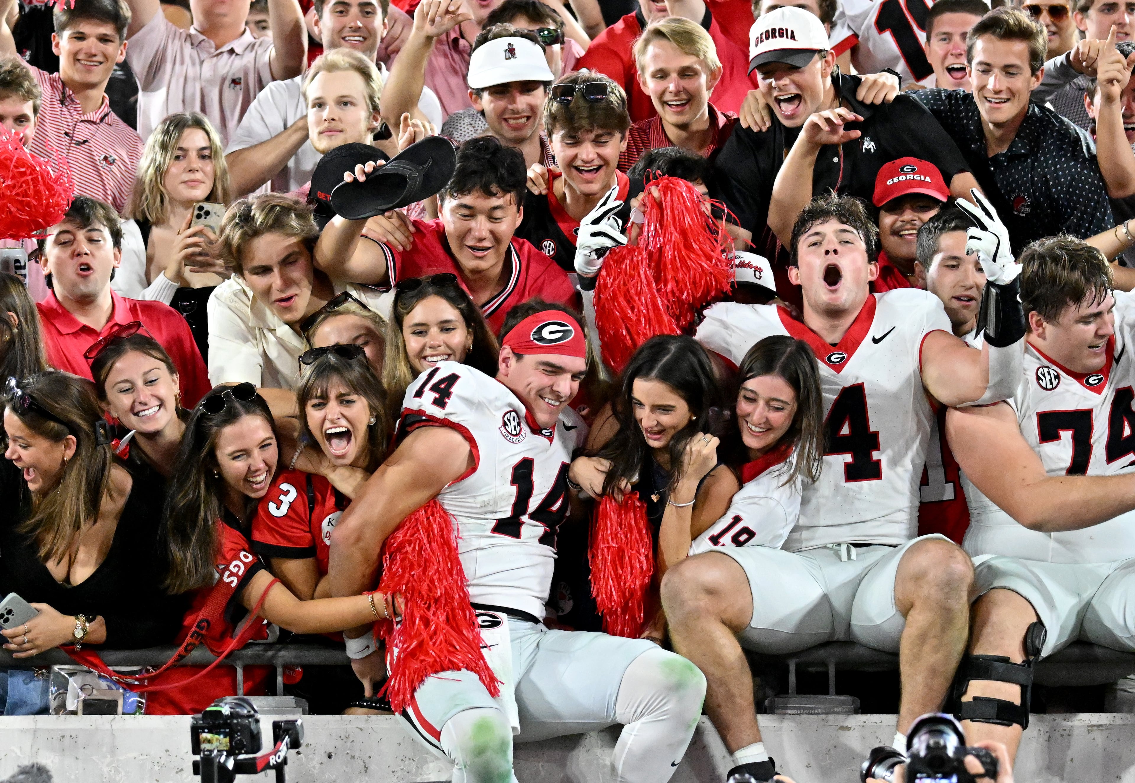 Georgia quarterback Gunner Stockton (14) and other players celebrate with fans after Georgia beat Florida during an NCAA football game, Saturday, November 1, 2025, Jacksonville, Fla. Georgia won 24-20 over Florida. (Hyosub Shin / AJC)