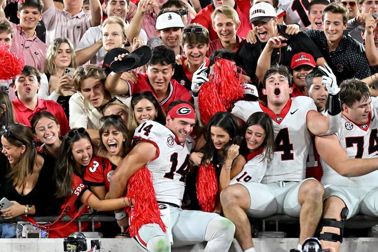 Georgia quarterback Gunner Stockton (14) and other players celebrate with fans after Georgia beat Florida during an NCAA football game, Saturday, November 1, 2025, Jacksonville, Fla. Georgia won 24-20 over Florida. (Hyosub Shin / AJC)