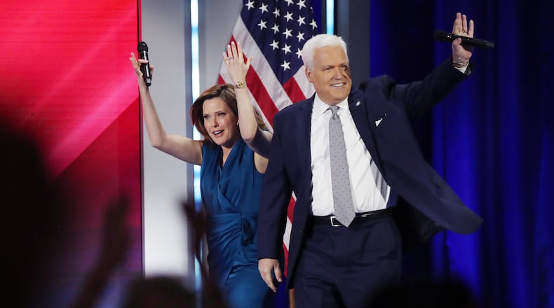 Mercedes and Matt Schlapp walk onstage to a cheering crowd during CPAC at the Hyatt Regency in Orlando, Florida, in February. A former aide to the U.S. Senate campaign of Herschel Walker has accused Matt Schlapp of sexually harassing him. (Stephen M. Dowell/Orlando Sentinel/TNS)
