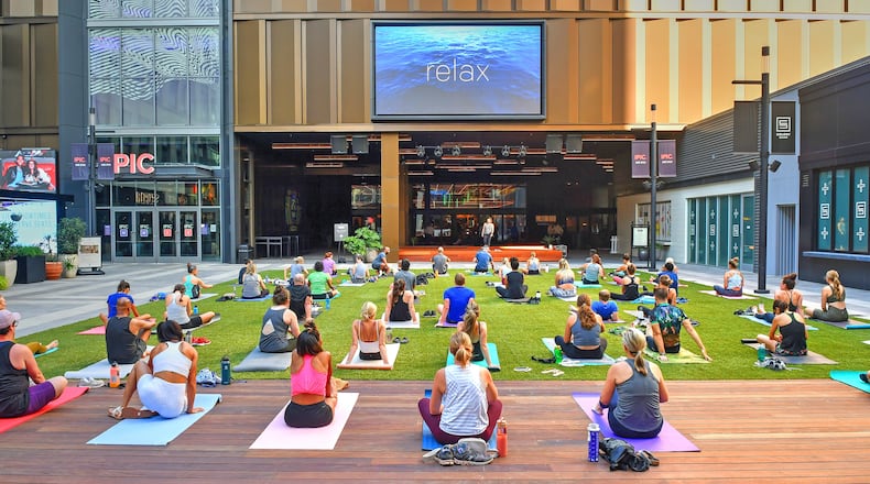 A grass courtyard that offers yoga classes is just outside the entrance to the new Politan Row food hall at Colony Square, 1197 Peachtree Road, Atlanta Ga. Photos taken Wednesday June 23, 2021. (Chris Hunt for The Atlanta Journal-Constitution)
