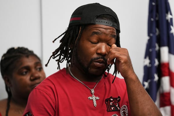 One of sexual assault survivor Michael Moss wipes his eyes as he listens to Jerome Block, partner, Levy & Konigsberg LLP, during a news conference in Chicago, Wednesday, July 16, 2025. (AP Photo/Nam Y. Huh)
