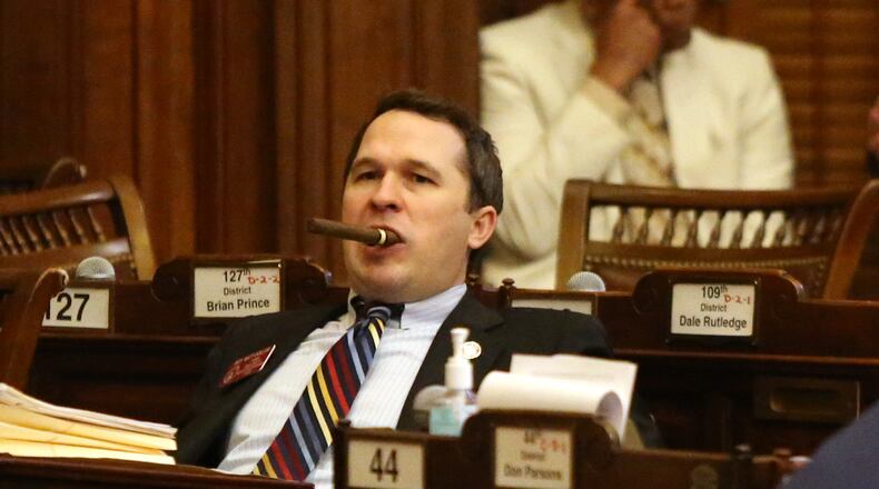 4/2/19 - Atlanta- Representative Matt Dollar, district 45, holds a cigar in his mouth while a bill is being presented at the Georgia State Capitol in Atlanta, Georgia on Tuesday, April 2, 2019. Today is sine die day, the final day of the 2019 legislature. EMILY HANEY / emily.haney@ajc.com