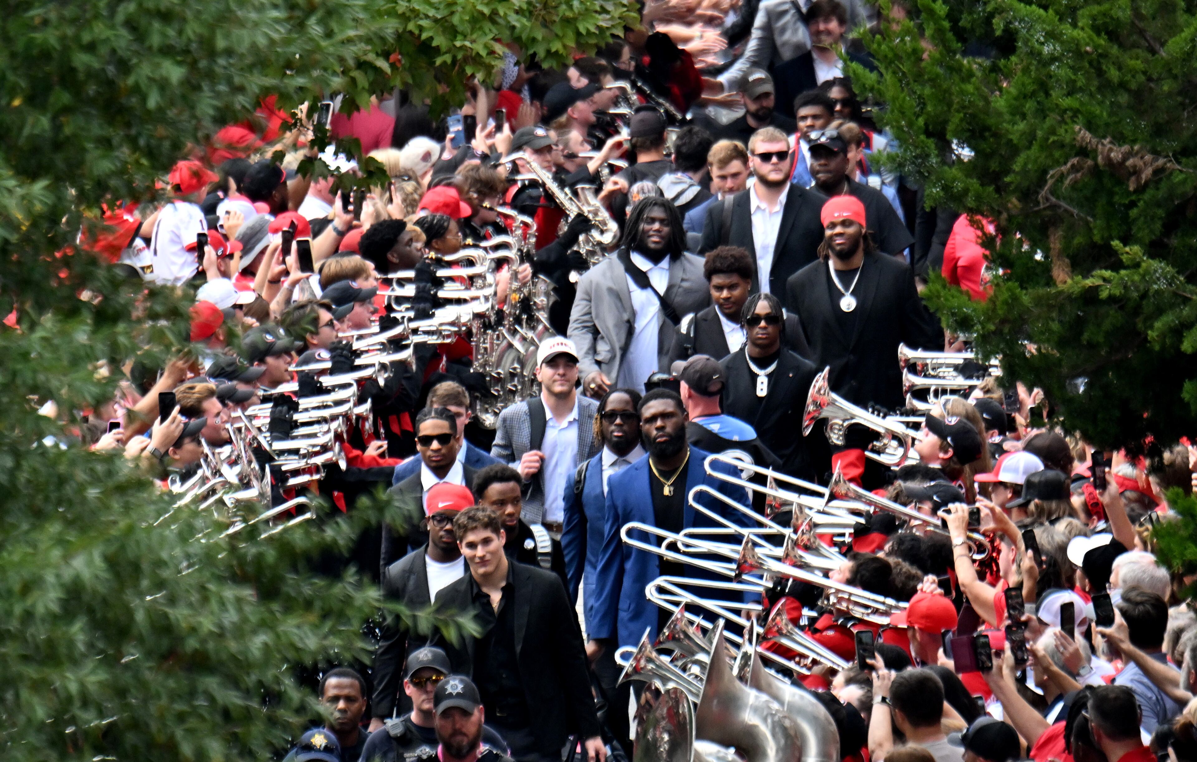 Georgia players and coaching staff arrive during the Dawg Walk before an NCAA football game against Mississippi at Sanford Stadium, Saturday, October 18, 2025, in Athens. (Hyosub Shin/AJC)